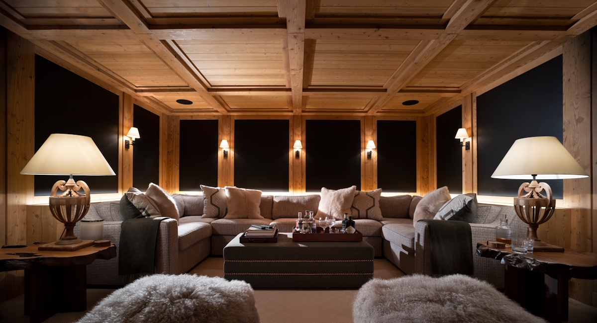 Nicky Dobree winter chalet large wraparound sofa, fur textured stools and large ornate lamps