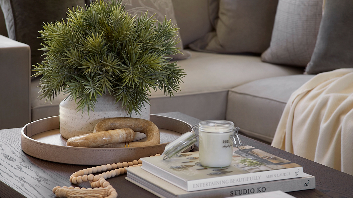 Luxury wood coffee table display, leather round Pinetti tray coupled with faux flowers and marble ornament.